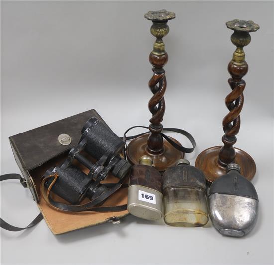 A set of military binoculars, a pair of candlesticks and three hip flasks